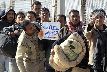 Egyptians who fled Libya a few days ago queue to board a plane heading for Egypt