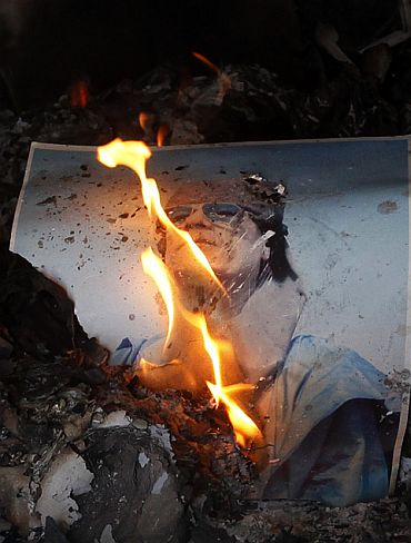 A burning picture of Libyan leader Muammar Gaddafi