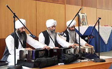 Bhai Harmohan Singh and his brothers sing hymns at the memorial