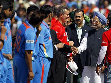 PM Singh and Pak PM Gilani meet with match official Billy Bowden (in red) and Indian players ahead of the ICC Cricket World Cup semi-final match