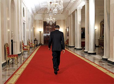 US President Barack Obama walks down the Cross Hall of the White House after announcing the death of Osama bin Laden