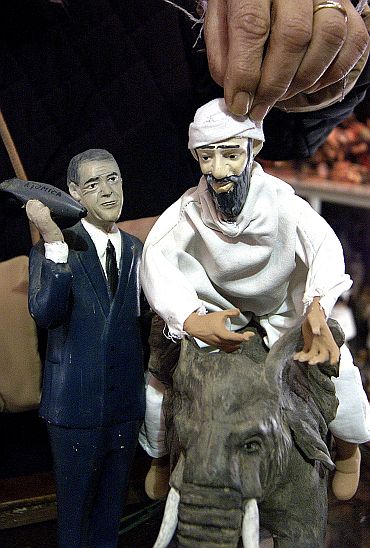 Figurines depicting bin Laden escaping from  Afghan and Bush holding an atomic bomb