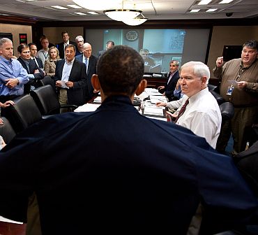 President Barack Obama talks with members of the national security team