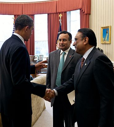 President Barack Obama meets with President Asif Ali Zardari of Pakistan, right, and Husain Haqqani, Pakistan's ambassador to the United States, centre, in the Oval Office