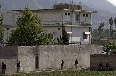 Pakistani security personnel surrounding the compound where Al Qaeda leader Osama bin Laden was killed in Abbottabad