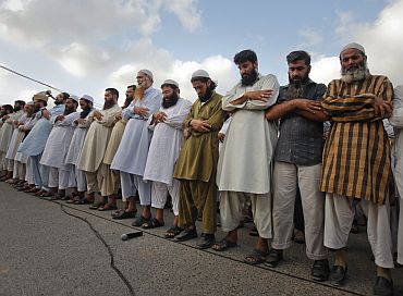 Supporters of banned Jamaat-ud-Dawa weep as they take part in a funeral prayer for Osama in Karachi