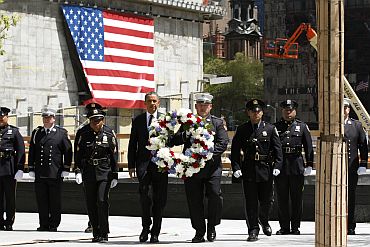 US President Obama carries a wreath during a wreath laying ceremony in tribute of 9/11 victims in New York