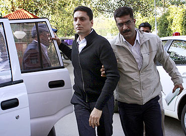 CBI officials escort Shahid Balwa at the CBI headquarters in New Delhi