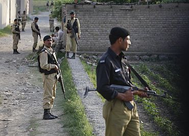 Pakistan Army soldiers keep guard outside bin Laden's compound