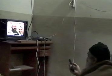 Bin Laden is shown watching himself on television, with US President Barack Obama also on screen, in this video frame grab released by the US Pentagon