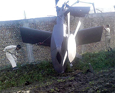 Part of a damaged helicopter used by US Navy SEALs lying in bin Laden's compund in Abbottabad
