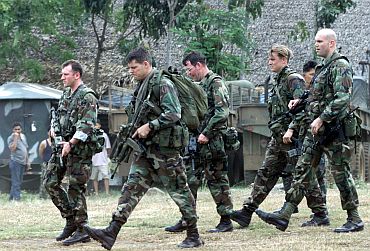 U.S. Green Beret soldiers walk inside the 103rd Philippine army brigade camp near Isabela, capital of the southern island of Basilan.