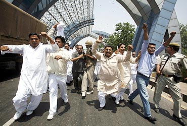 Farmers shout slogans during a protest march at Noida