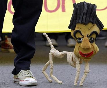 A student performs with a marionette effigy of Colombian President Juan Manuel Santos during a protest in Bogota. Thousands of students and teachers marched in a nation wide protest against the education government's reform of public universities, student organizations reported