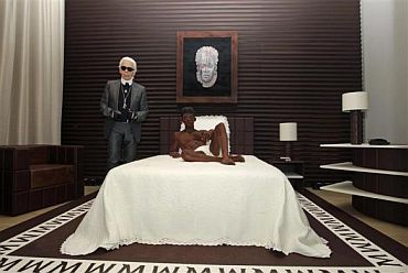 German designer Karl Lagerfeld poses as he unveils his hotel suite creation made of chocolate, part of a campaign by a leading ice cream brand, at a hotel in Paris