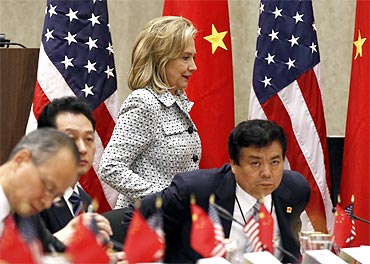 Hillary Clinton walks past the Chinese delegations