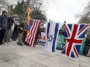Demonstrators set fire to flags of US, Israel and Britain following a special prayer for Al Qaeda leader Osama bin Laden