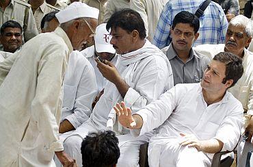 Congress leader Rahul Gandhi gestures to a villager during his visit to Parsaul village after Saturday's clash between farmers and police in Gautam Buddha Nagar district of Uttar Pradesh on Wednesday