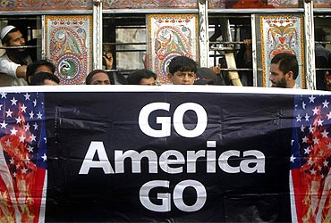 Supporters of Jamaat-e-Islami hold a banner during an anti-American rally