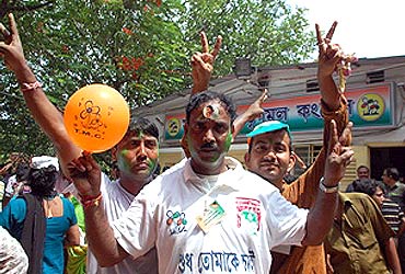 Trinamool supporters show the victory sign in Kolkata