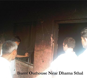 Rahul at a burnt down house near the protest spot
