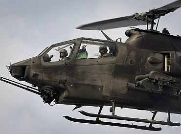 A Pakistani army AH-1 Cobra attack helicopter flies over Kund mountain near Kotkai village in South Waziristan
