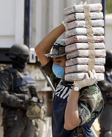 A marine carries packs of cocaine at a naval base in Manzanillo. The Mexican government said it belonged to drug lord Joaquin 'Shorty' Guzman