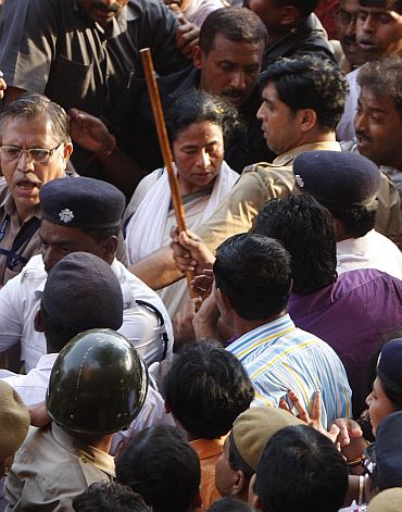 Police try to keep crowds at bay as Banerjee walks to Writer's Building.