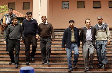 Lalit Bhanot and V K Verma accompanied by officials, leave CBI headquarters in New Delhi