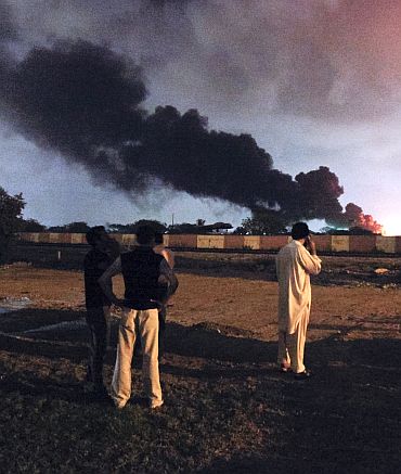 Smoke rises from a fire near airplanes inside the Mehran naval aviation base which was attacked by militants in Karachi