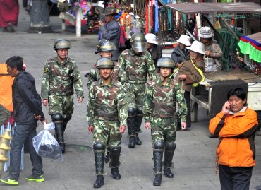 Armed paramilitary personnel patrol a street near Jokhang temple in Lhasa, Tibet