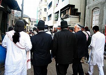 Jewish leaders from Israel and New York walk down a Colaba bylane, on the way to Nariman House