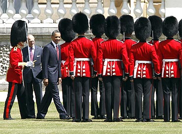 Obama reviews an honor guard with Prince Phillip, Duke of Edinburgh, during an official arrival ceremony at Buckingham