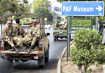 Soldiers depart from the Mehran naval aviation base after troops ended operations against militants in Karachi