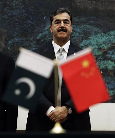 Pakistan's Prime Minister Yusuf Raza Gilani looks on as he attends a signing ceremony at the Great Hall of the People in Beijing