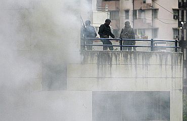 NSG commandos look down after explosion on fourth floor of Nariman House in Mumbai during 26/11 terror strikes