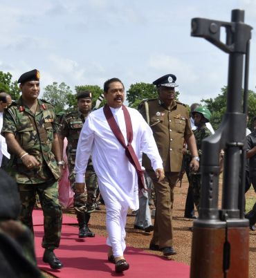 Sri Lankan President Mahinda Rajapaksa is escorted by the military to a cabinet meeting