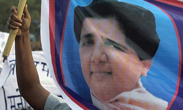 A BSP supporter holds a poster of Mayawati,