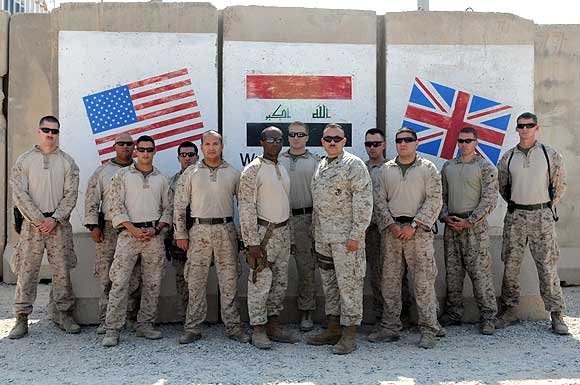 A team of 13 US Marine Corps trainers assigned to the Iraqi Marine Training Team gather for a photo