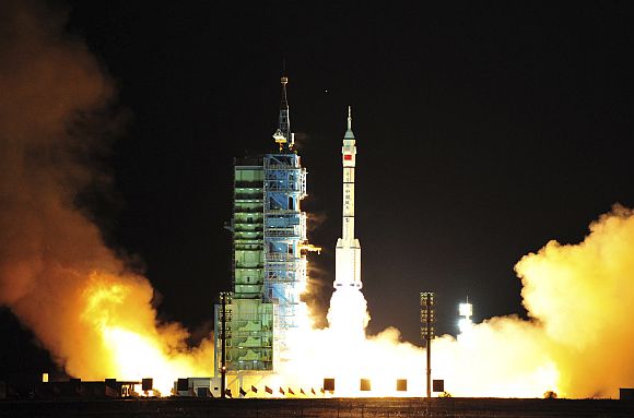 A Long March CZ-2F rocket carrying the unmanned spacecraft Shenzhou-8 blasts off from the launch pad at the Jiuquan Satellite Launch Center in China