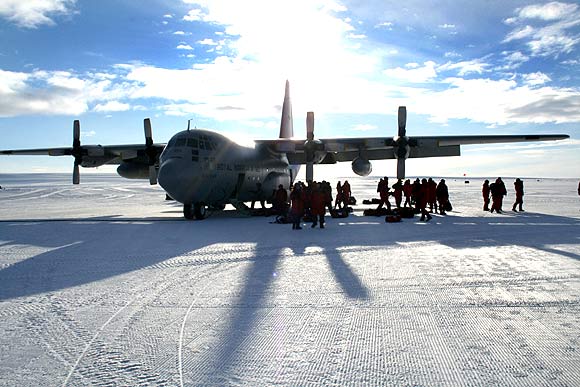 A Hercules transport plane stands on a frozen airstrip in Antarctica