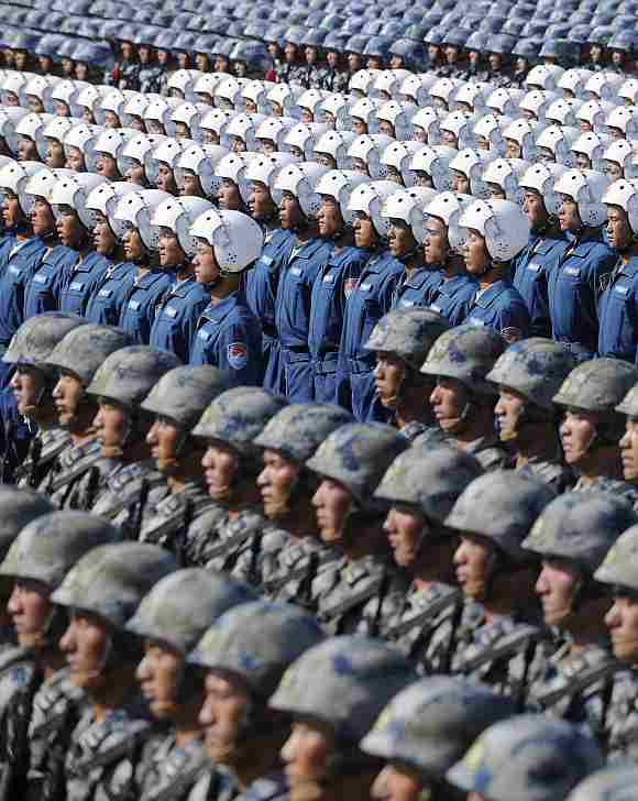 Soldiers from Chinese People's Liberation Army, Navy Marine Crops, Air Force Aviation and Airborne Corps (from top to bottom) stand at attention during a training session at the 60th National Day Parade Village on the outskirts of Beijing.