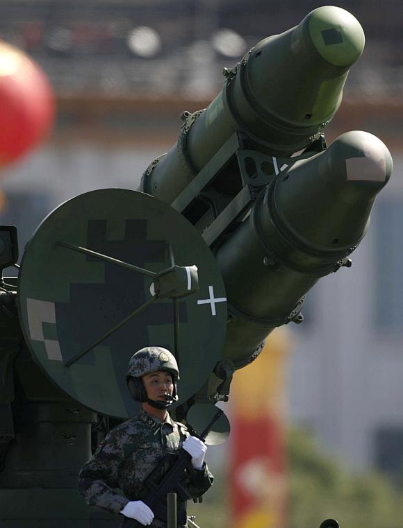 A PLA soldier is seen in front of a rocket launcher during a massive parade to mark the 60th anniversary of the founding of the People's Republic of China in Beijing