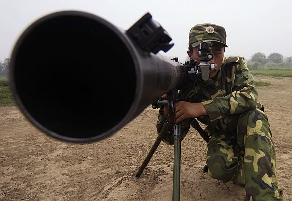 A soldier practices shooting during a training session at a military base in north China