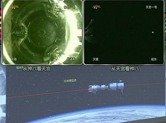 Tiangong (Heavenly Palace) 1 module (top L) as it docks with the Shenzhou 8 spacecraft