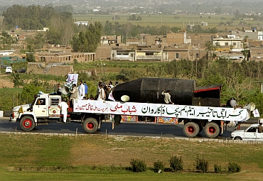 Members of the fundamentalist youth organization, Shabab-e-Milli, drive a truck carrying a mock nuclear bomb through Islamabad, as part of its campaign to build support for Pakistan's nuclear programme