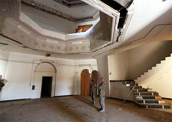 US soldiers tour a building within Victory Base Compound in Baghdad on November 7. The US military is vacating Saddam Hussein's ornate palaces at its war headquarters in Baghdad and will turn the property over to Iraq next month, but Saddam's prison toilet is leaving with the Americans.