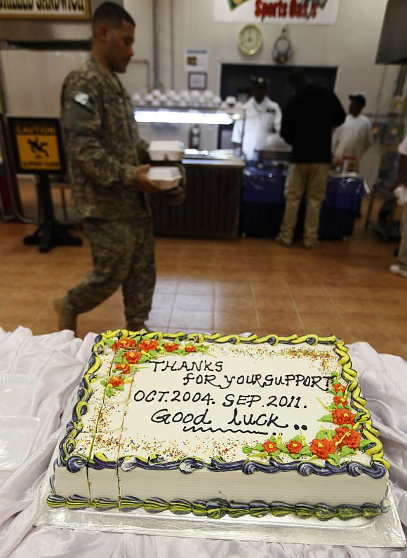 A US soldier walks past a cake at Camp Liberty in Baghdad