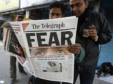 File image of people in Siliguri reading a newspaper carrying reports of the 26/11 attacks in Mumbai