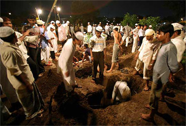 A file photo of people digging graves for blast victims